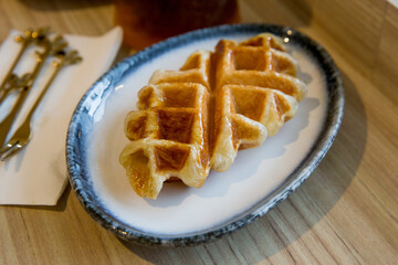 Obraz na płótnie Canvas Plain Waffle on wooden background. Traditional Food.