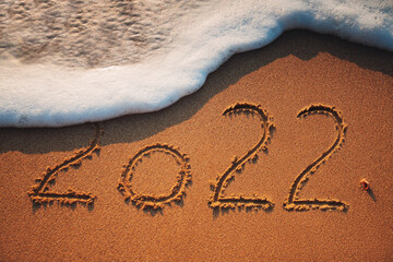 Happy New Year 2022 concept on the sea beach; sunrsie shot