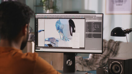 Unrecognizable guy creating and rendering 3D model of futuristic robot for film while working on remote project at home - obrazy, fototapety, plakaty