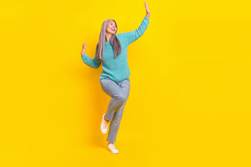 Full length body size view of attractive cheerful grey-haired woman dancing good mood isolated on bright yellow color background