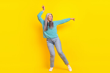 Fototapeta na wymiar Full length body size view of attractive cheerful carefree woman dancing isolated on bright yellow color background