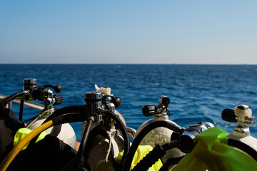 Many scuba tanks with air on yacht in the sea. 