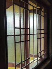 old window with glass lid and iron trellis