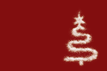 Merry Christmas and a Happy New Year. Christmas card - a white Christmas tree shape made of salt, like snow, on a red background. Minimal holiday concept