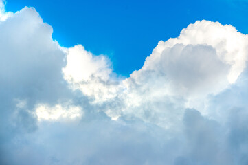 Cumulus clouds. Background with white clouds floating above the ground at flight altitude. Picture for weather forecast.