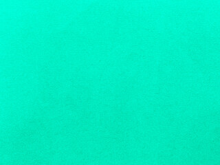 Mint green velvet fabric texture used as background. Empty green fabric background of soft and smooth textile material. There is space for text..