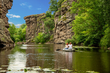 tourism life style beautiful nature photography with people in boat and river surrounded by rocks and cliff