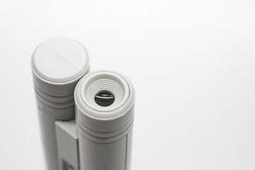 Compact mini microscope for printing and design. Magnifying device. Selective focus, copy space, white background