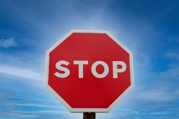Stop sign over blue sky background