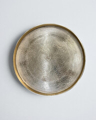 New luxury cutlery view from above on a isolated white background. Top view. Golden saucer. Trendy plate pastel shades. Flat lay view.