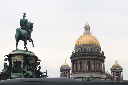 the bronze horseman on the background of St. Isaac's Cathedral