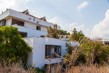 Abandoned building exterior view of Hotel in the Turkish village of kemer with broken windows and...