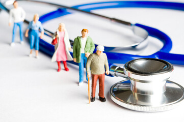 people figurines and stethoscope, public health system and medicare concept