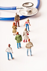 people figurines and stethoscope, public health system and medicare concept