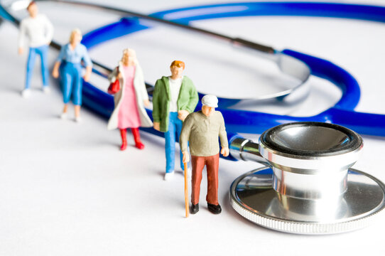 People Figurines And Stethoscope, Public Health System And Medicare Concept