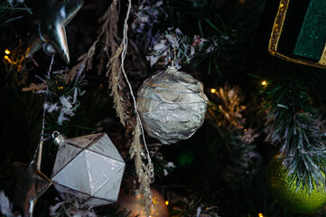 close-up of silver and gold decorations, foil ball on christmas tree