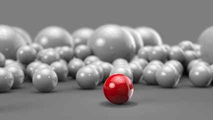 Red ball in focus with bunch of white balls behind it - red one stands out