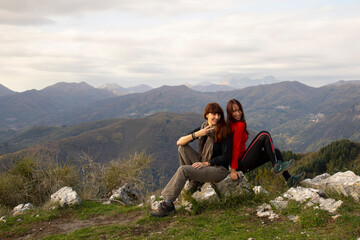 Naklejka premium Two middle aged women on top of a mountain in autumn
