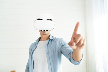 Young man wearing Virtual reality glass working on touching simulation screen analyzing the data at home