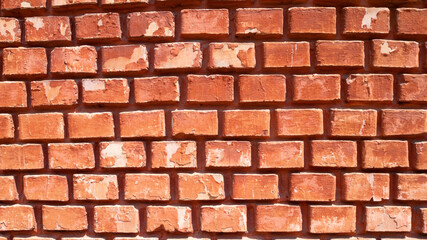 Part of a red brick wall with narrow masonry. 16:9