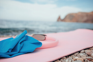 Magic pilates ring and rubber band on yoga mat near sea Female fitness yoga concept. Healthy lifestyle harmony and meditation.