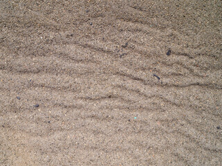 Top view of undulating gray asphalt that has begun to deform due to the high heat. Global warming concept.
