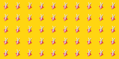 Seamless pattern. Easter bunnies isolated on yellow background. Funny texture. Education toy theater online course. Hand puppet. Sewing hobby. Fairy tale character. Fluffy baby play friend. Wallpaper
