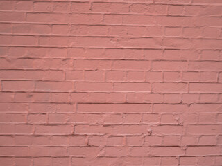 Obraz premium Fragment of a pale pink and gray brick wall. Abstract pastel background.