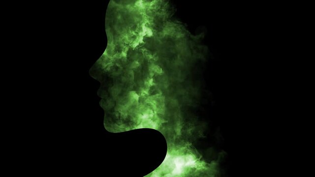 Silhouette of a person head with green animated smoke 