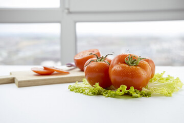fresh tomatoes on green lettuce