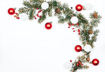 Natural pine branch with toys and red berries on a white background. Christmas background - obrazy, fototapety, plakaty