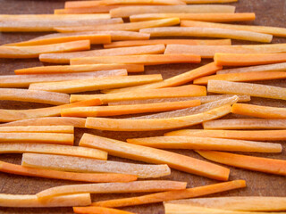 Closeup of julienne carrot on a wooden board.