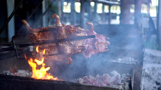 Suckling pig Chinese food whole baby pig roasted with charcoal turning around