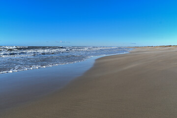 Piémanson beach in winter with wind, sand and waves. Camargue.