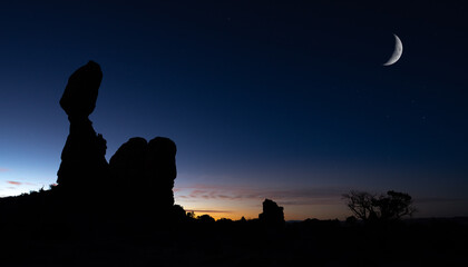 balanced rock in arches national park with sunset
