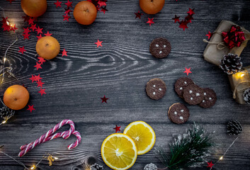 Moscow, Russia, December 2021, background with Christmas decor, cookies, Christmas decorations, tangerines, garland of lights, lollipops and orange slices