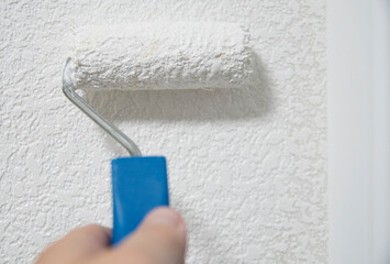 A roller that paints the wall with paint