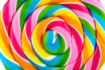 Fototapeta na wymiar A macro photo of a sweet colorful lollipop in the shape of a spiral, isolated on a white background, top view.