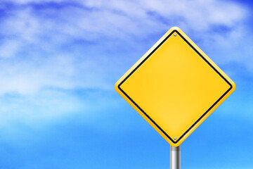 Blank warning road sign with sky background