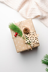 Christmas gift box with wooden snowflake decorations on white