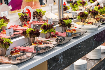 Hotel open buffet breakfast selection.. Salami, ham and delicious types of cheese and in the...