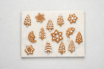 Decorated homemade gingerbread cookies. Festive sweet treat on gray background, top view. Christmas composition with gingerbread pastry