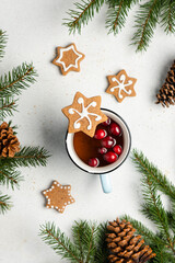 Cranberry drink and Decorated homemade gingerbread cookies. Festive sweet treat on gray background,...