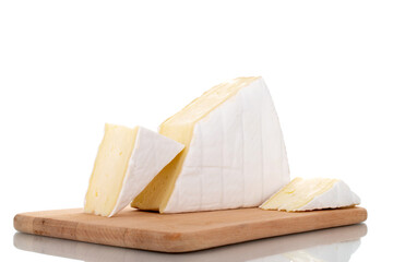 Three fragrant pieces of brie cheese on a wooden board, close-up, isolated on white.
