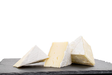 Three fragrant pieces of brie cheese on a slate stone, close-up, isolated on white.