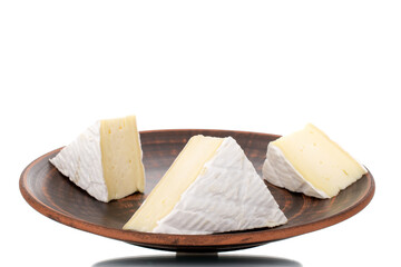 Three fragrant pieces of brie cheese on a ceramic platter, close-up, isolated on white.