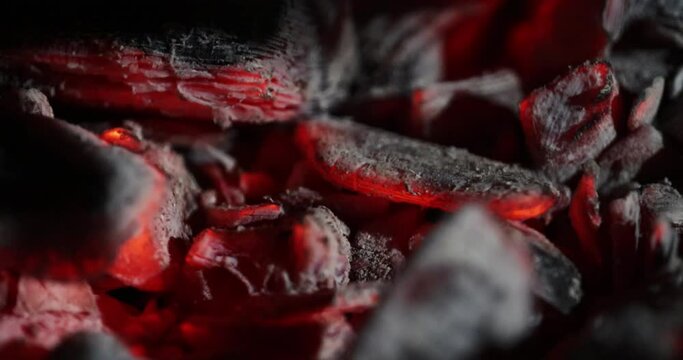 Smoldering hot coals on a barbecue grill.
