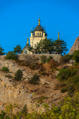 FOROS, CRIMEA - View from observation platform of Baidarsky Pass on the Church of Christ's Resurrection rising on the abrupt 400-metre (1312 ft) Red Cliff (Krasnaya Skala) above Black sea in twilight.