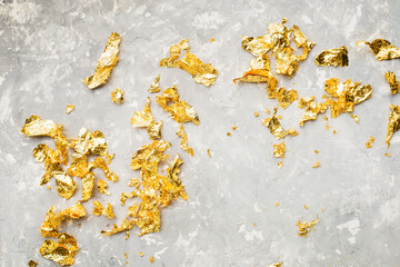 Gold patal foil background. Luxurious mock up for background. Top view. Gold on gray. Colors of the Year.