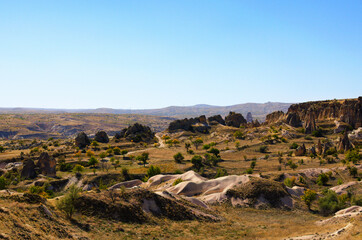 Scenic aerial landscape view of geologic formations of Cappadocia. Amazing shaped sandstone rocks. Famous touristic place and romantic travel destination. Picturesque autumn view